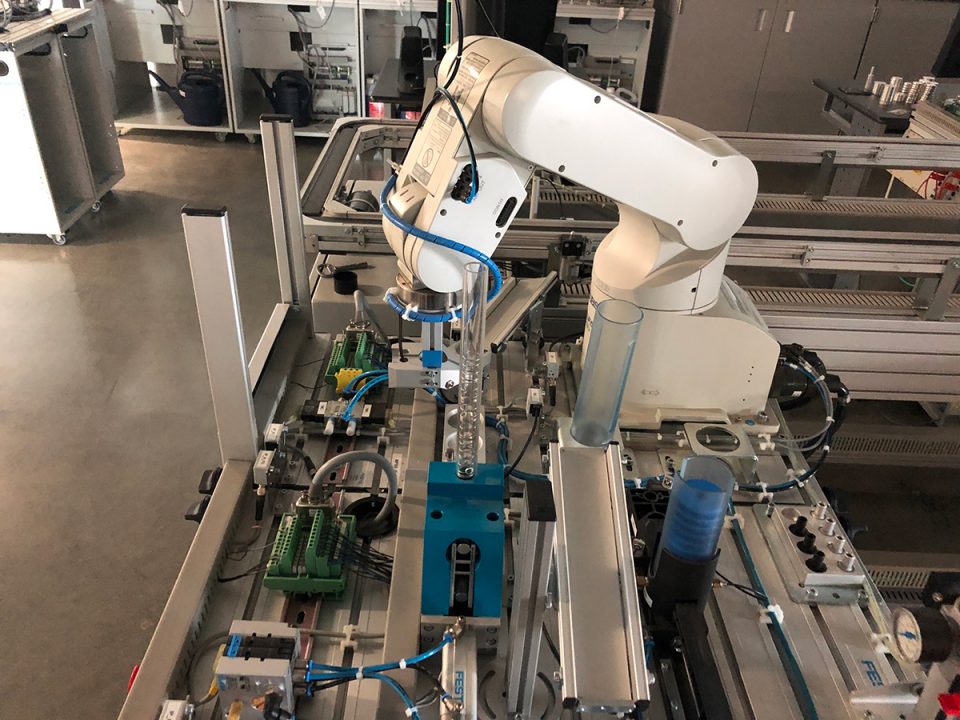 Robotic arm building circuits on metal