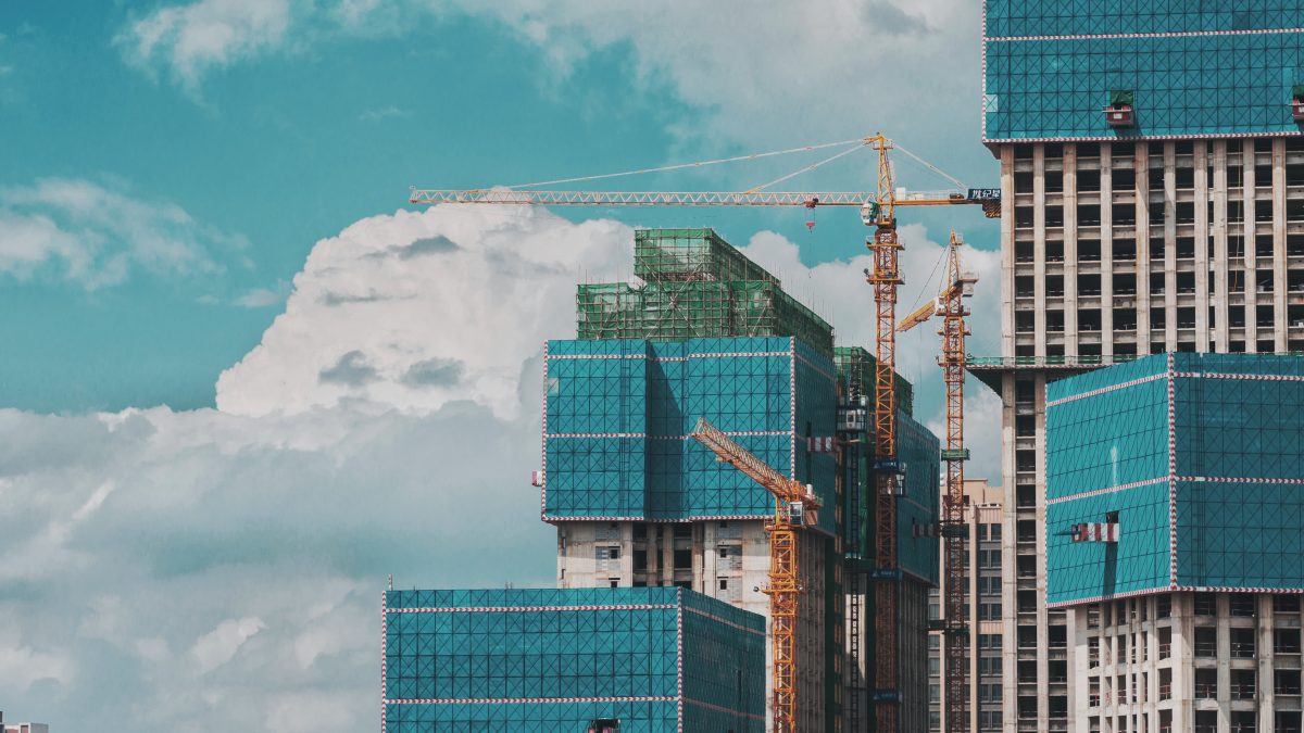 Blue themed skyscrapers being built with cranes